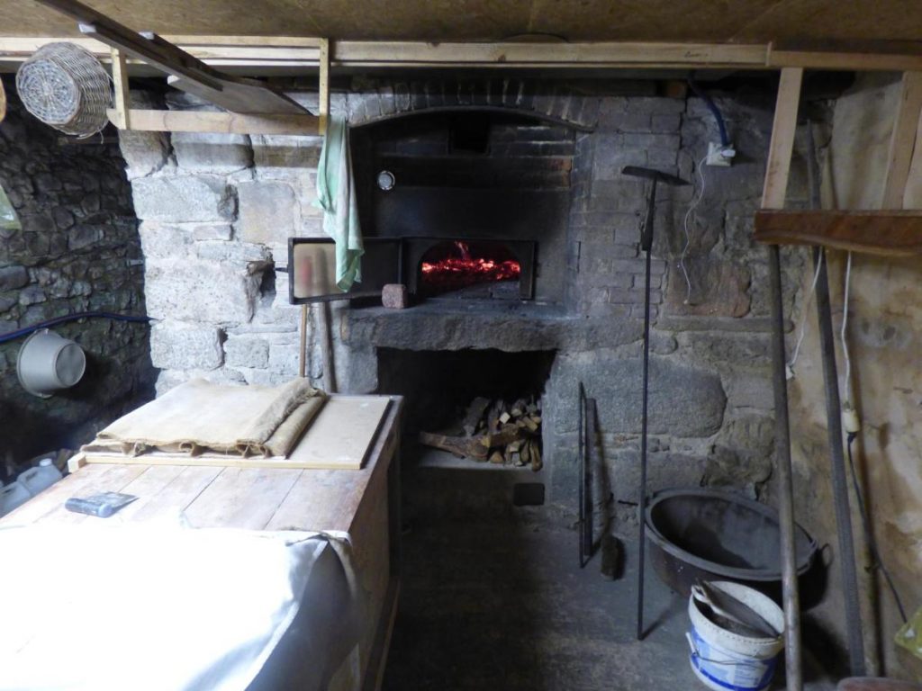 Jean-René préparant son pain au levain biologique dans le four à pierre traditionnel de Le Shamballa, Creuse.